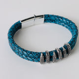 Black leather braided strap with silver and gold color embellishment