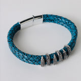 Black leather braided strap with silver and gold color embellishment