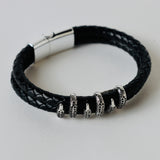 Black leather braided strap with silver and gold color embellishment