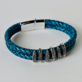 Black leather braided strap with silver and gold color embellishment
