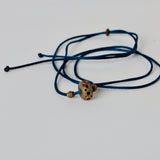 Black silk thread with african brass