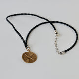 Brass pendant on leather chain
