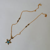 Evil eye in star shape in gold chain with swaroski stones