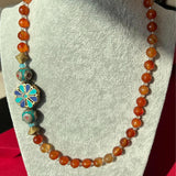 Beaded necklace paired with a Tibetan pendant on the side
