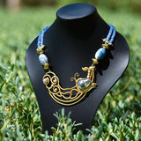 Statement necklace paired with blue crystals and Baroque pearls