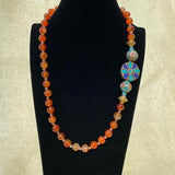 Beaded necklace paired with a Tibetan pendant on the side