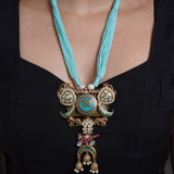 Himalayan Serenity: Sky Blue Thread Necklace with Tibetan Pendant & Jewel-Adorned Jhumki Drops" - Isaana Collection