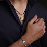 Brass pendant on leather chain
