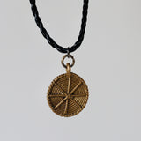 Brass pendant on leather chain
