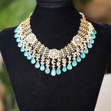 Ethinic golen necklace with green hued kemp stones : Isaana Collection
