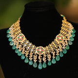 Ethinic golen necklace with green hued kemp stones : Isaana Collection